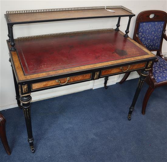 A late Victorian ebonised amboyna two drawer writing table W.108cm